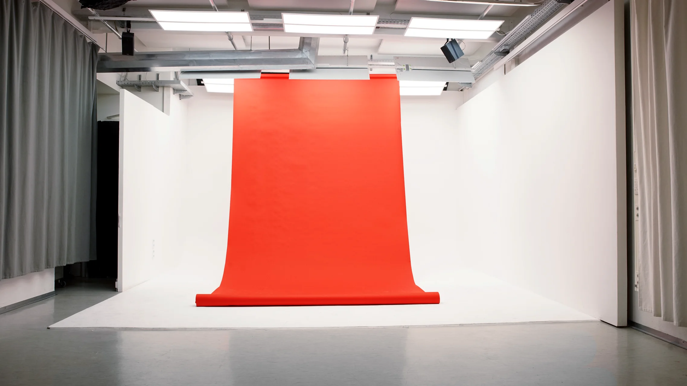 Modernes Fotostudio mit weißem Hintergrund und professionellem Licht-Setup